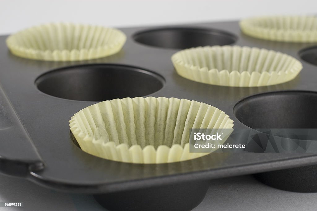 Giallo Cupcake rivestimenti in padella - Foto stock royalty-free di Ambientazione interna