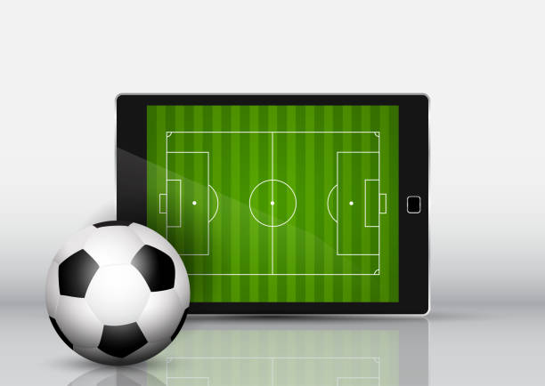 istock Soccer or football in front of an electronic device with pitch on screen 968993874