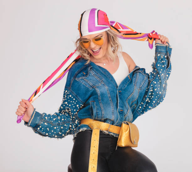 istock happy woman with rock outfit pulling her headscarf 968994656