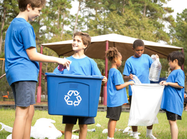 istock Multi-ethnic group of school children recycling at park. 969005210
