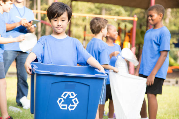 istock Multi-ethnic group of school children recycling at park. 969005278
