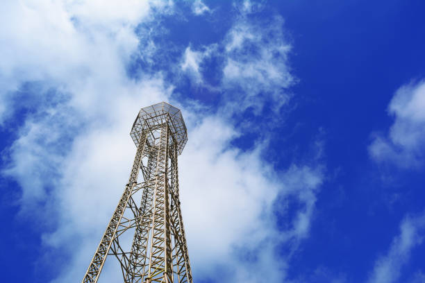 high iron tower and  deep blue sky with white clouds at clear day in afternoon