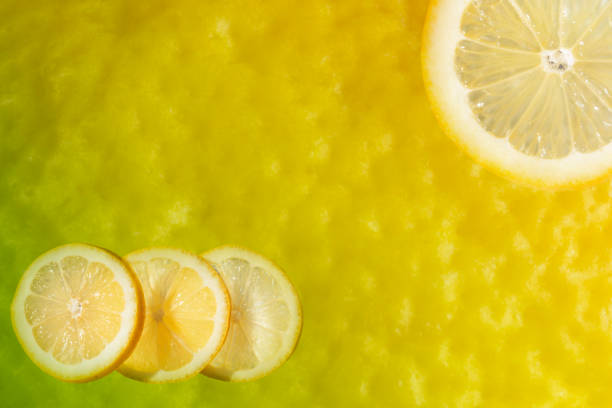 Lemon slices on a lemon skin background ,macro photo ,post production composition ,vibrant colors