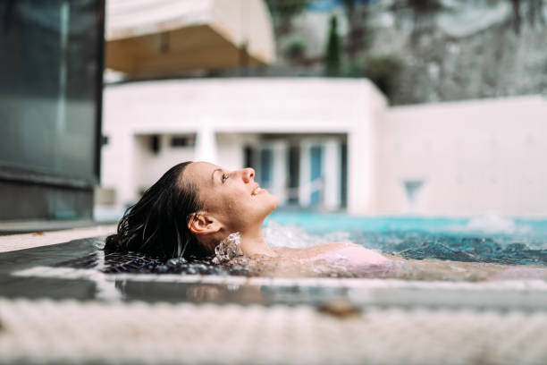 istock Smiling woman in the pool at spa resort. 969013122