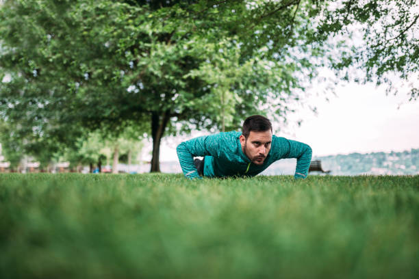 istock Young man doing push ups in the park. 969013476
