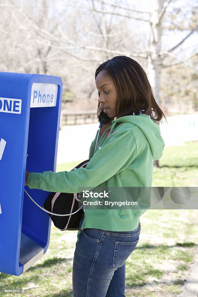 Using a Pay Phone  Adult Stock Photo