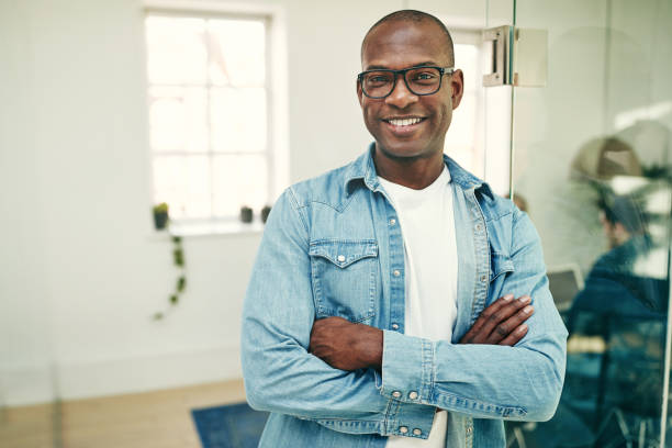 istock Smiling young African businessman working in a modern office 969028228