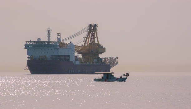 istock breakwater, and ships on the horizon. 969031398