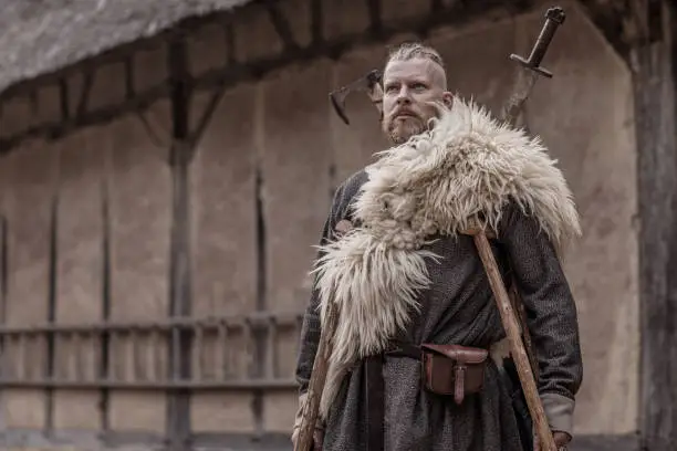 Caucasian Bearded Viking Warrior Chief Male near farmhouse surroundings