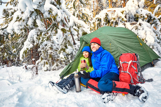istock Walk through the winter forest with a backpack and tent. 969034954
