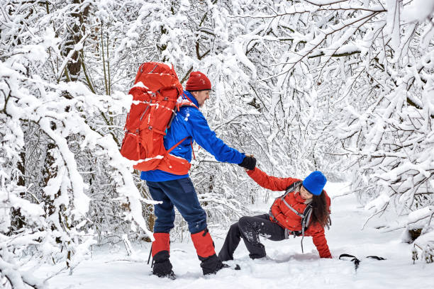 istock Walk through the winter forest with a backpack and tent. 969035164