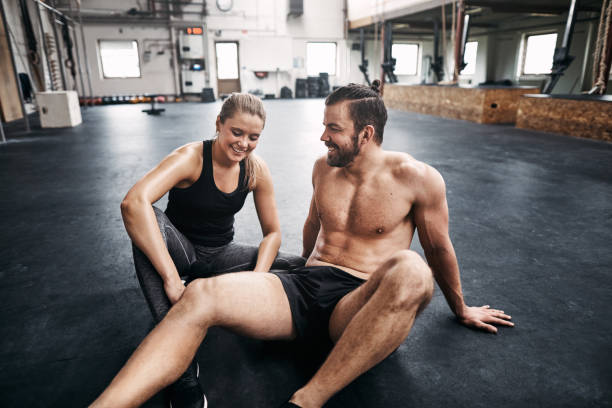 istock Two people resting resting on a gym floor after exercising 969038016
