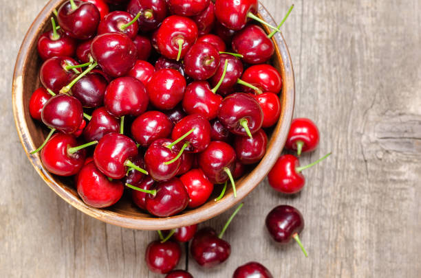 istock Fresh cherry on wooden background. 969038528