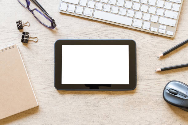 istock top view wooden office desk with computer, tablet with blank screen, and supplies 969039842