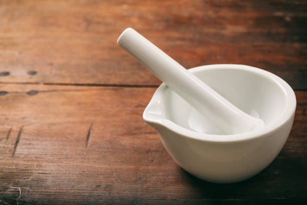 White set of mortar and pestle on wooden background