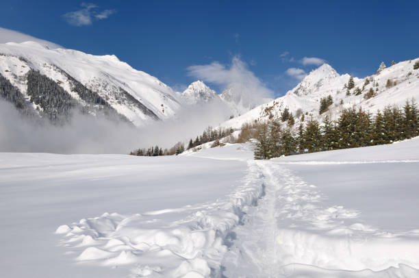 istock path in the snow crossing mountain 969042248