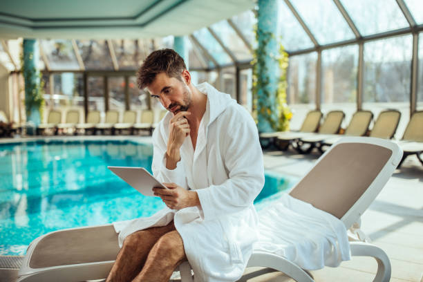 istock Online surfing by the spa 969042738