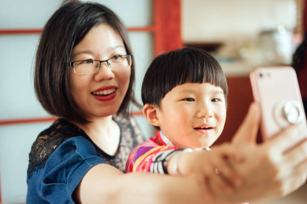istock Beautiful chinese family taking selfies 969043522