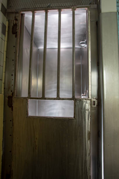 istock Metal door with bars on shower stall in prison 969048674
