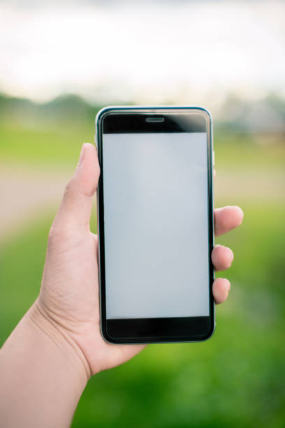 istock Hands hold smartphone with graphs marketing and cyber technology background. Marketing checking on smartphone. 969076132