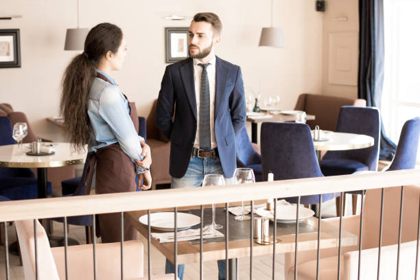 istock Frowning restaurateur talking to waitress 969077208