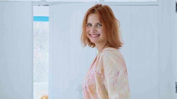 istock Charming happy young woman smiling and looking at camera 969077268
