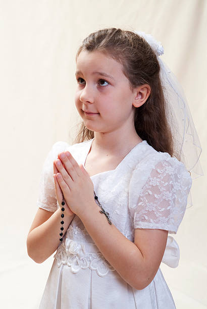 istock Young girl's first communion, holding a rosary 96907880