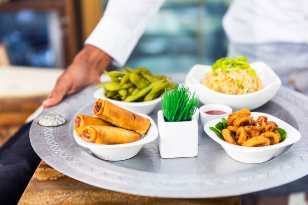 Waiter holding a Chinese Food Platter