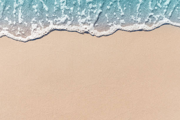 Soft wave lapped the sandy beach, Summer Background. Soft wave lapped the sandy beach, Summer Background. tide stock pictures, royalty-free photos & images