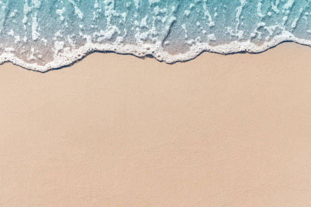 soft wave lapped the sandy beach, summer background. - sand imagens e fotografias de stock