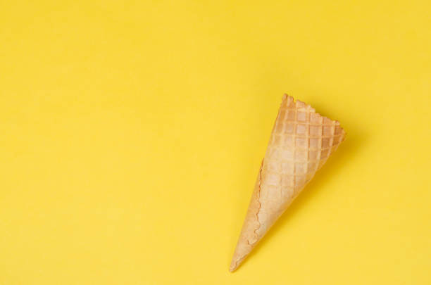 istock Ice cream waffle cone over yellow background with copy space for text, logo or wordings insertion or decoration, summer cold sweets 969089364