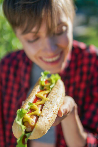 istock Woman eating hot dog 969090430