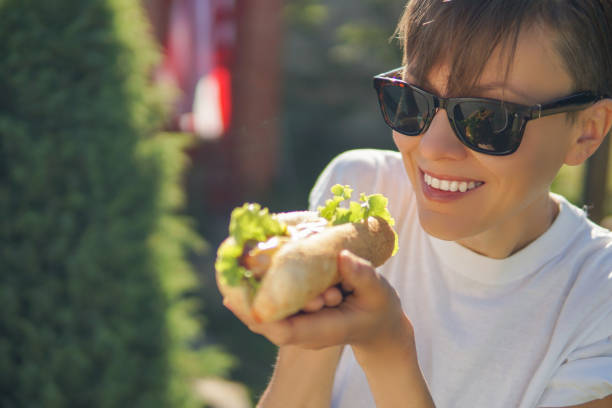 an asian chinese woman enjoying her local czech food in prague downtown