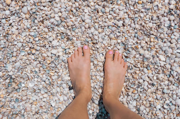 istock Female legs on a sandy beach 969091112