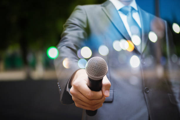 istock Speaker holds out the microphone. 969103102