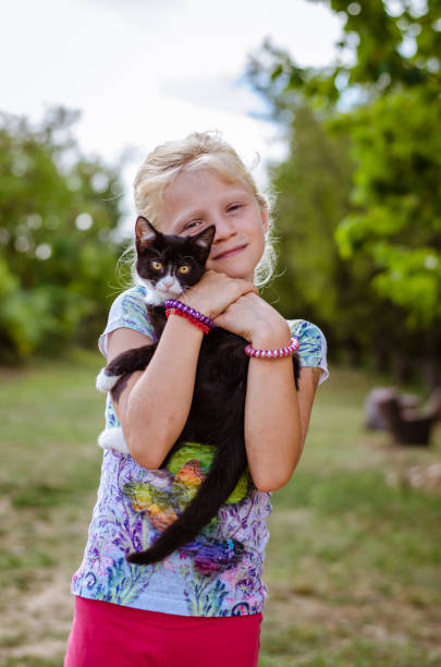 istock child holding little cat pet 969107188