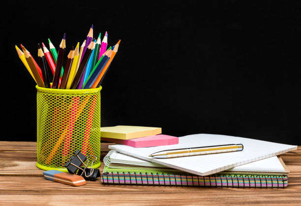 istock School supplies on table against blackboard. Education concept. 969108110