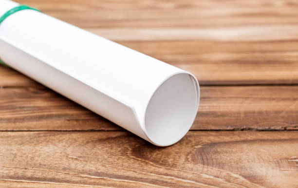 istock Paper rolled into a roll on the wooden table. Close up. 969111312