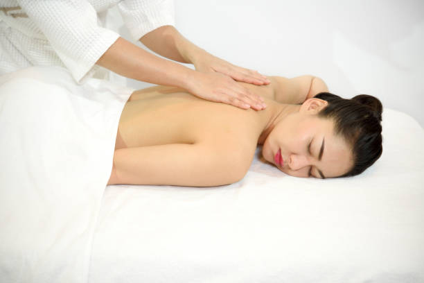 istock Young beautiful woman lying in spa room. 969115264