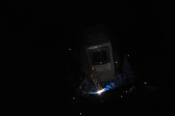 istock Welder welding metal in workshop with sparks 969115840