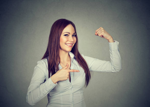 istock Strong girl showing muscles 969118590
