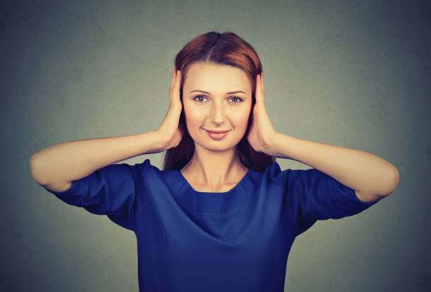 istock Woman covering ears from gossips 969118764