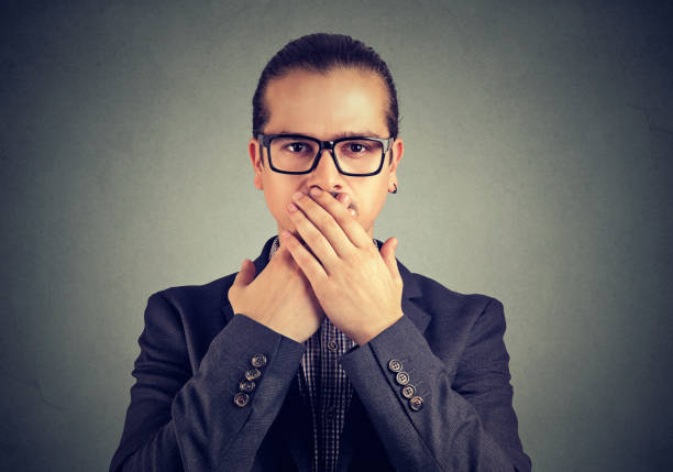 istock Confident man covering mouth in conspiracy 969118820