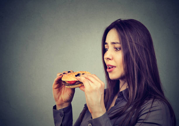 istock Young woman craving for burger 969119140