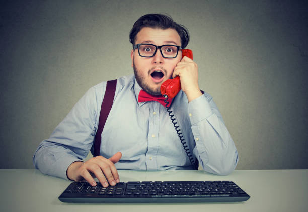 istock Shocked man speaking on phone at workplace 969122356