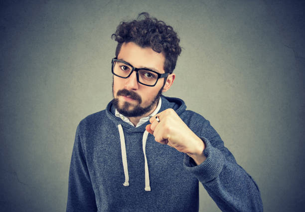 istock Aggressive man threatening with fist 969122400