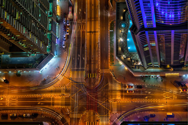 驚くべきシティライト センター交差点、道路交通、アラブ首長国連邦での夜の間にドバイのスカイラインのトップ ビュー - futuristic dubai city traffic ストックフォトと画像