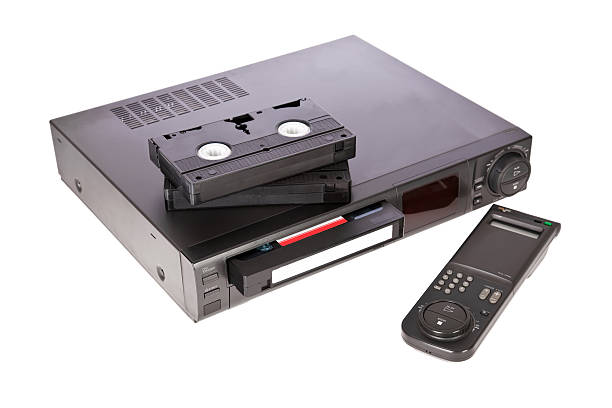 istock Old Video Cassette Recorder and tapes isolated on white 96912281