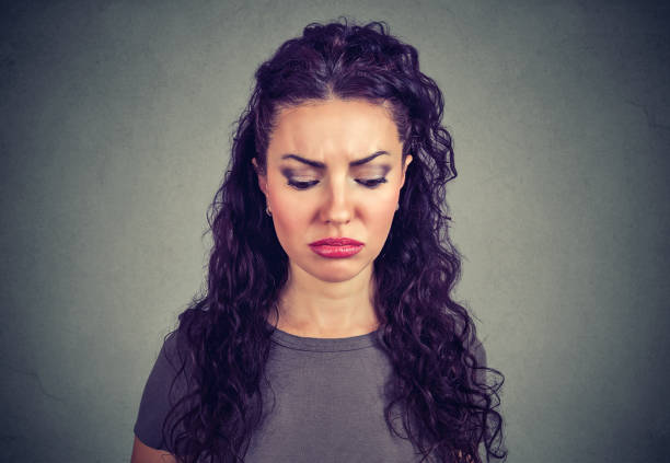 istock Sad young woman looking down 969123024
