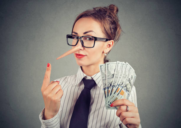 Liar businesswoman with dollar cash and sly look Financial fraud concept. Liar businesswoman with dollar cash and sly look ponzi scheme stock pictures, royalty-free photos & images